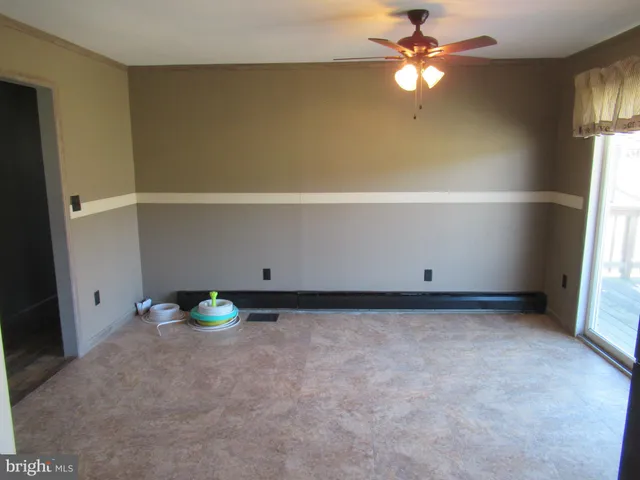 a view of room with window and ceiling fan