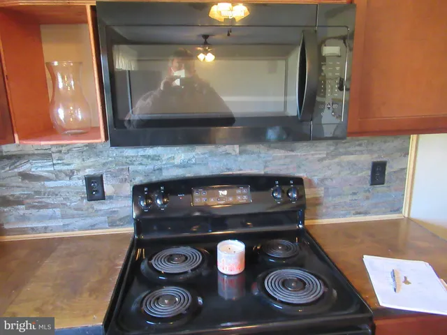a kitchen with a stove and a microwave