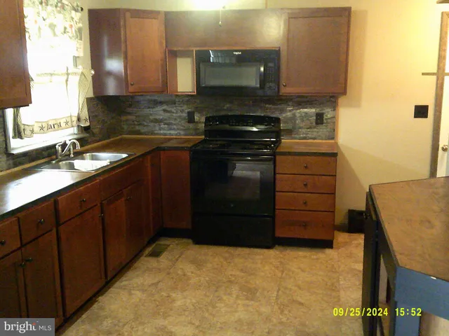 a kitchen with a refrigerator and a sink