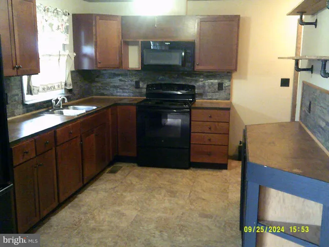 a kitchen with a stove and a sink