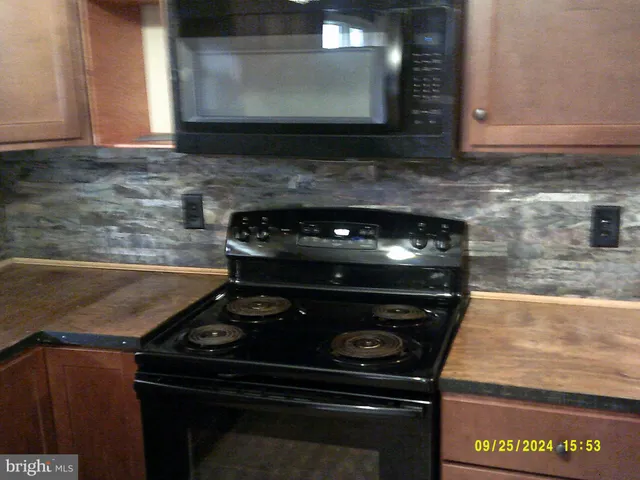 a stove top oven sitting inside of a kitchen