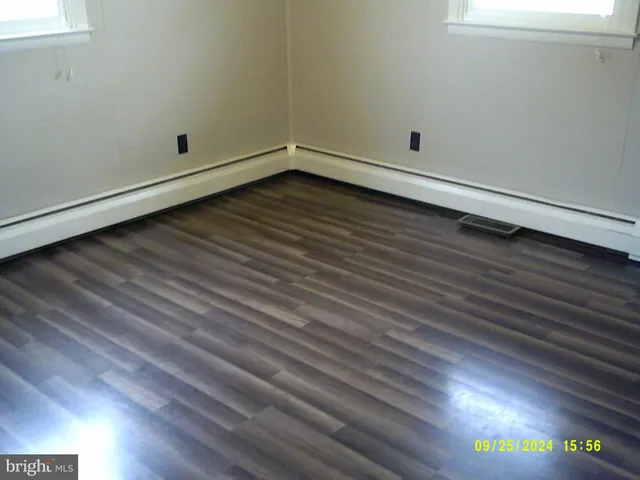 a view of a closet with wooden floor