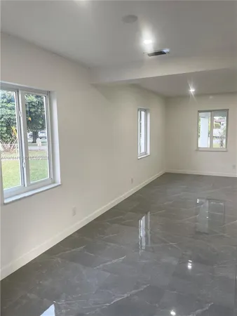 a view of empty room with windows