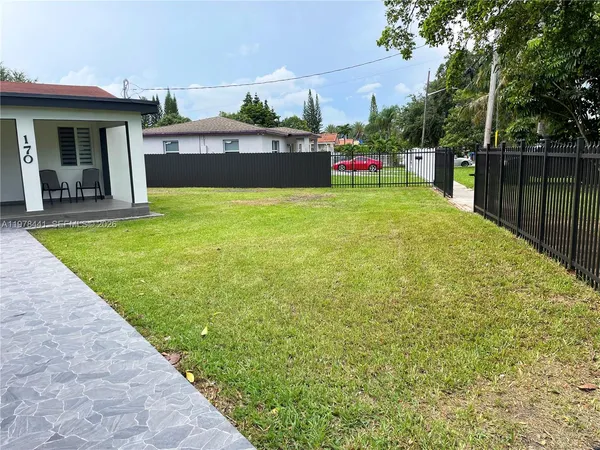 a view of a house with backyard and porch