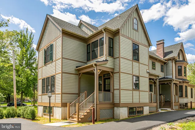 a view of a white house with large windows