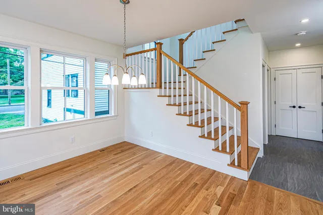 a view of entryway and hall with wooden floor