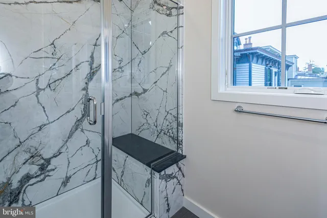 a bathroom with a shower and a sink