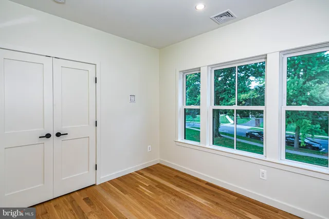 a view of room with window and hardwood floor