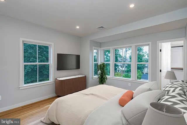 a bedroom with a bed and large window