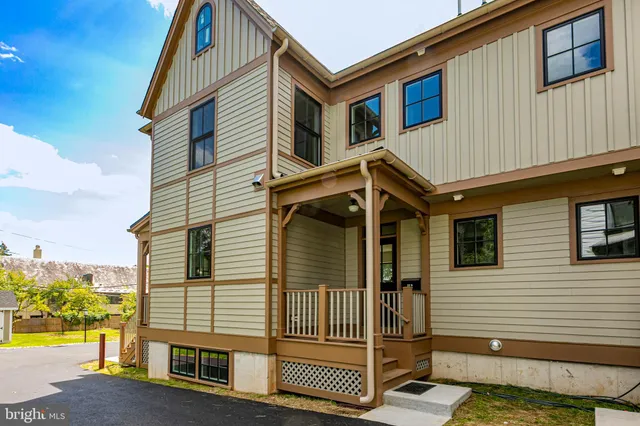 a view of a house with a wooden deck