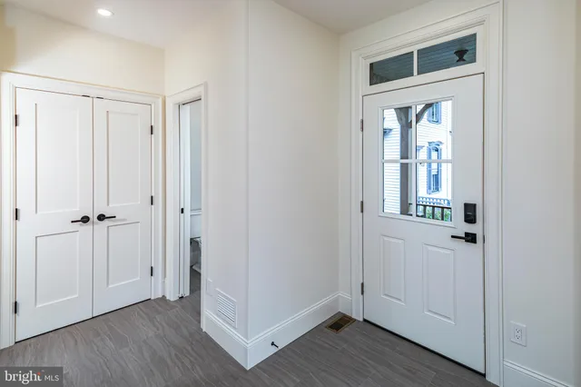 a view of an entryway with wooden floor
