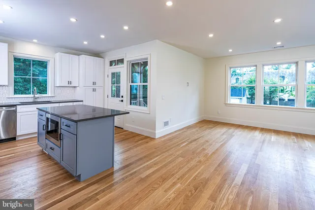a kitchen with wooden floors and sink