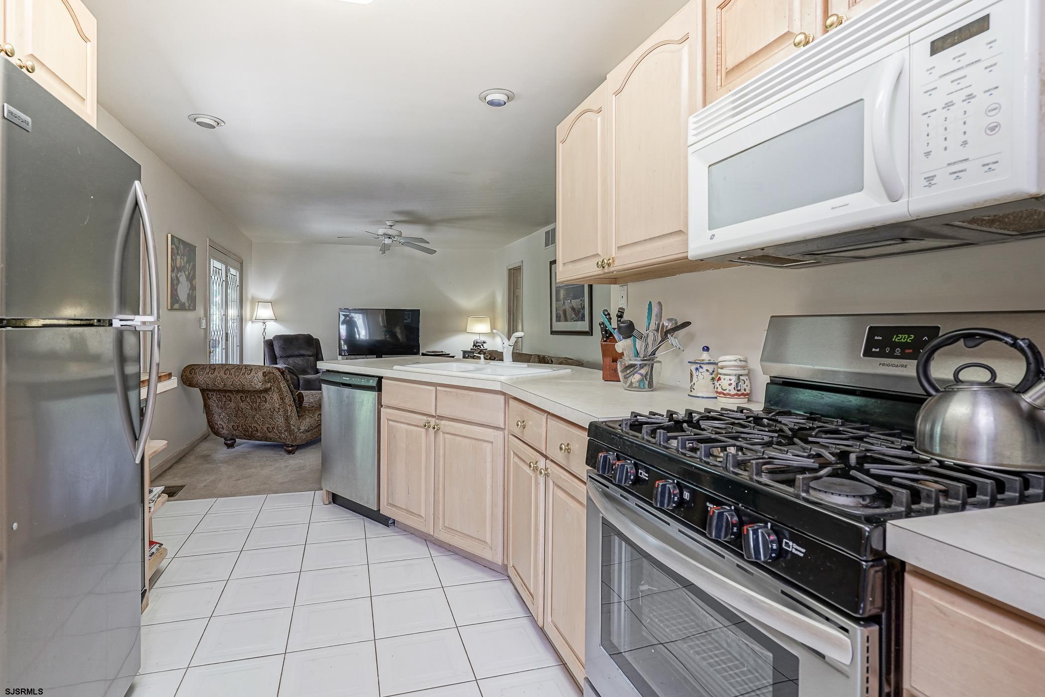 1099 Somers Point Road Egg Harbor Township, NJ 08234 - Photo 20 of 55 a kitchen with stainless steel appliances a stove a sink and a refrigerator