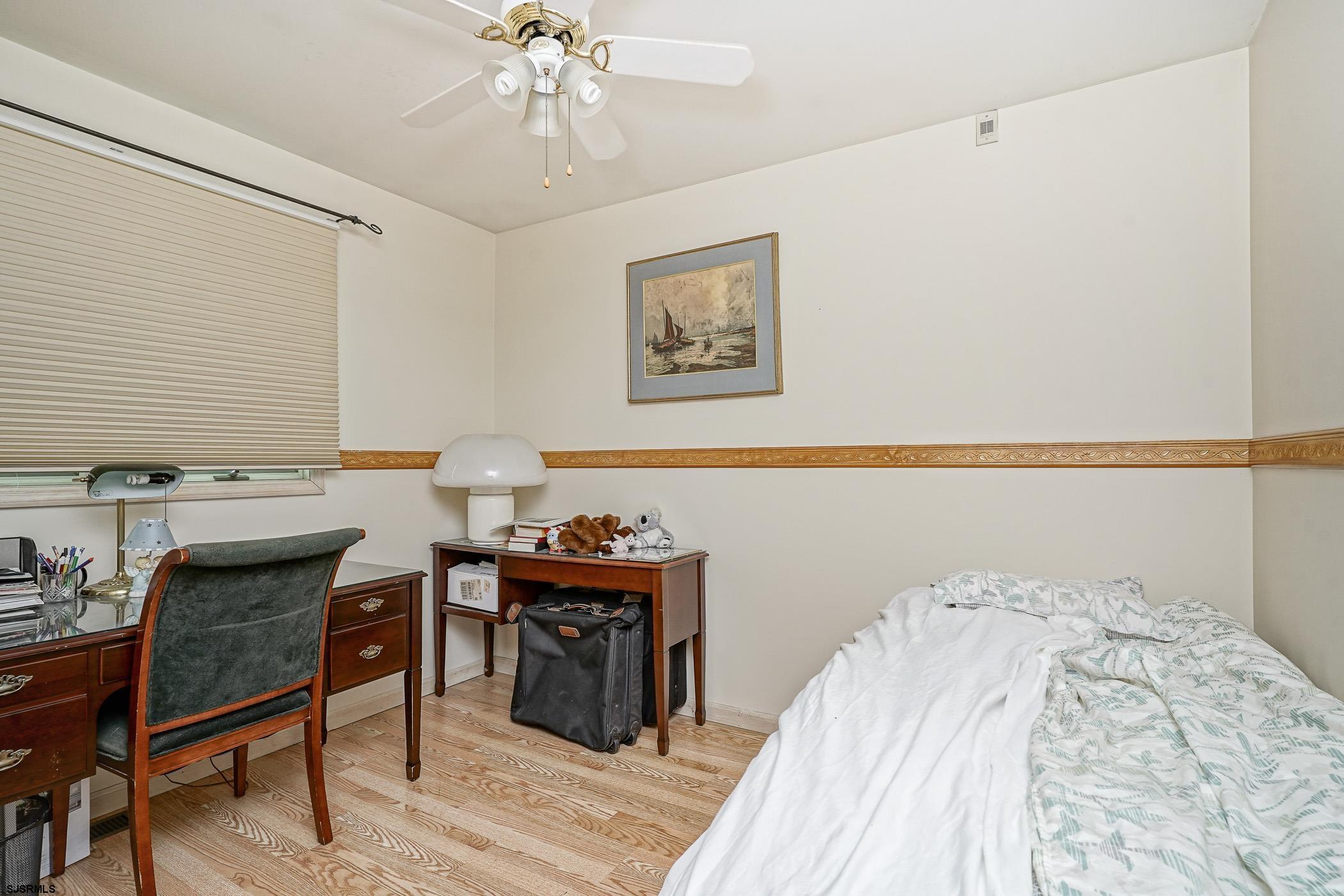 1099 Somers Point Road Egg Harbor Township, NJ 08234 - Photo 2 of 55 a bedroom with a bed and a table in it