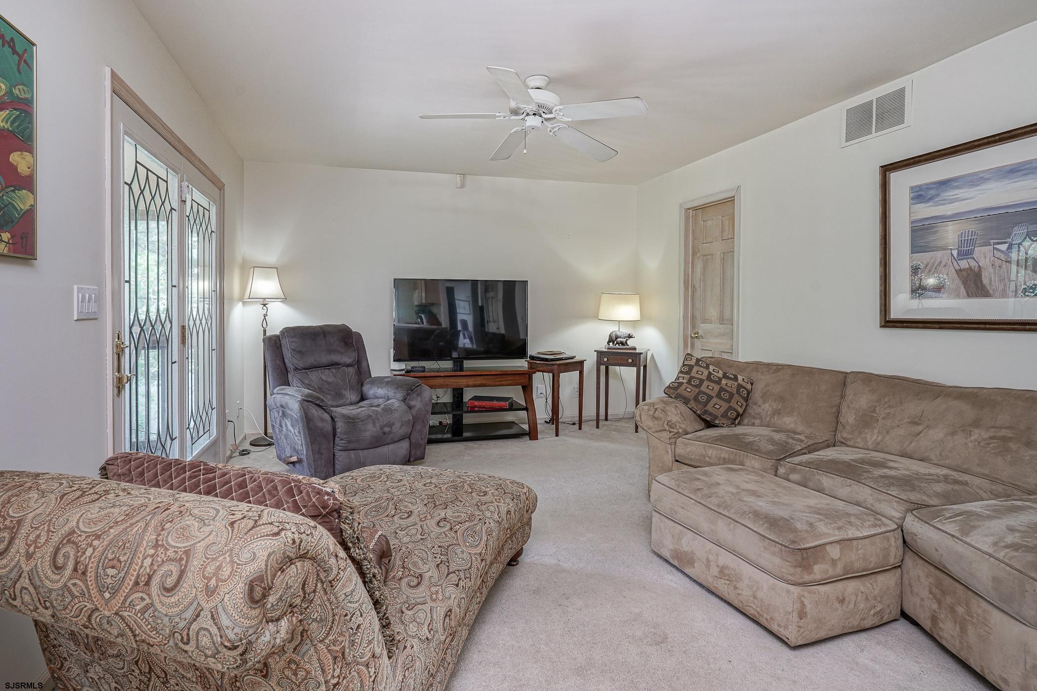 1099 Somers Point Road Egg Harbor Township, NJ 08234 - Photo 21 of 55 a living room with furniture and a flat screen tv