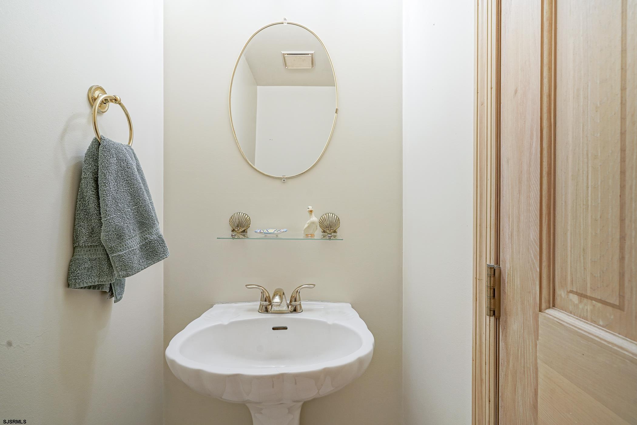 1099 Somers Point Road Egg Harbor Township, NJ 08234 - Photo 24 of 55 a bathroom with a sink and a mirror