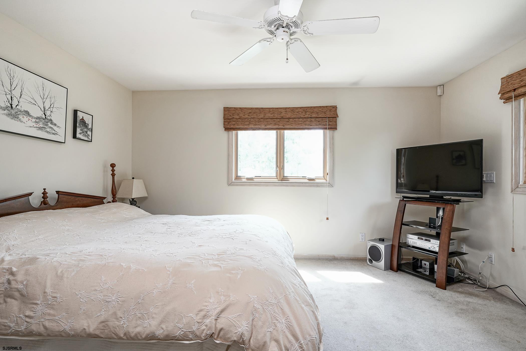 1099 Somers Point Road Egg Harbor Township, NJ 08234 - Photo 30 of 55 a bedroom with a bed and a flat screen tv