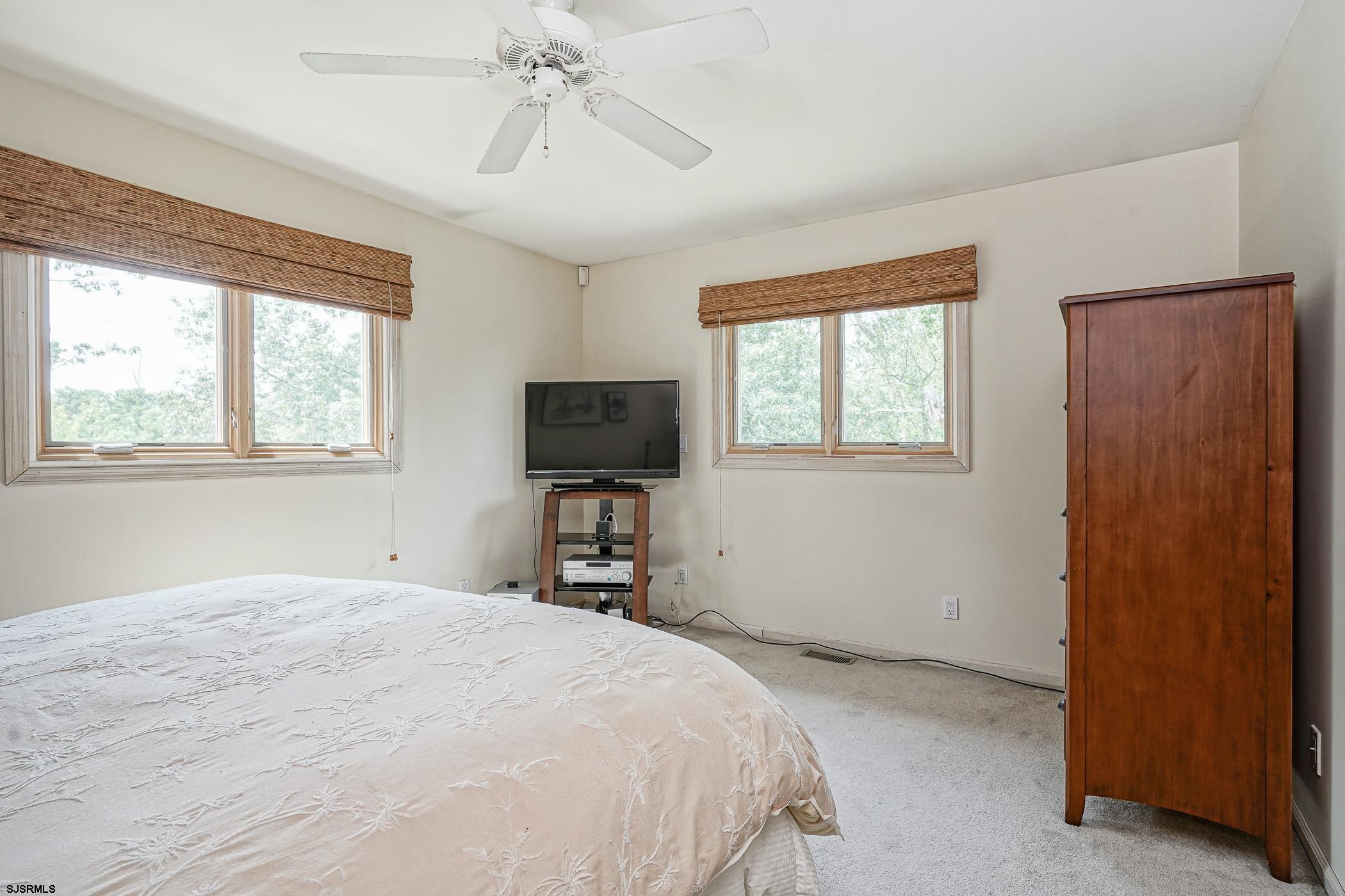1099 Somers Point Road Egg Harbor Township, NJ 08234 - Photo 31 of 55 a bedroom with a bed and a flat screen tv