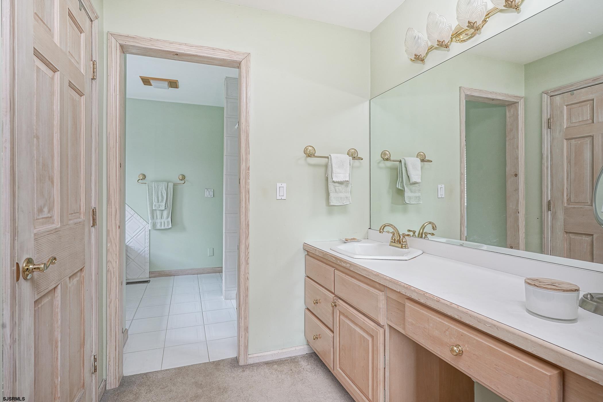 1099 Somers Point Road Egg Harbor Township, NJ 08234 - Photo 32 of 55 a bathroom with a sink and a mirror