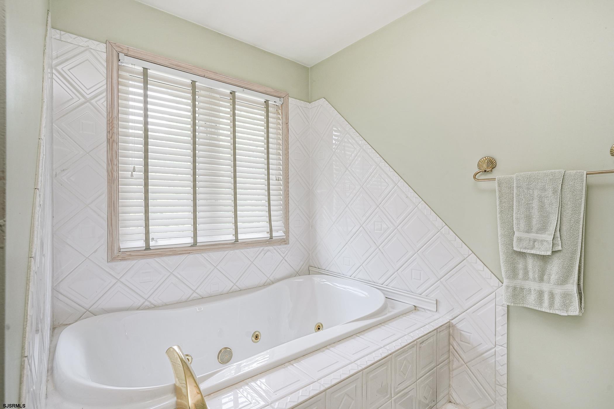 1099 Somers Point Road Egg Harbor Township, NJ 08234 - Photo 33 of 55 a bathroom with a bathtub and a window