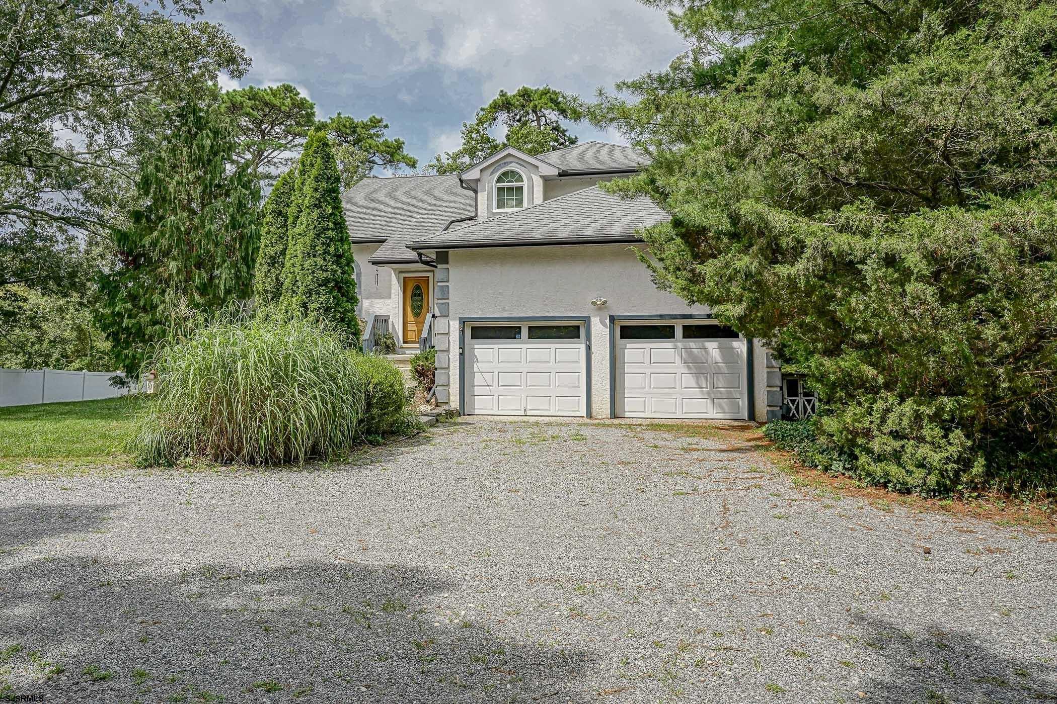 1099 Somers Point Road Egg Harbor Township, NJ 08234 - Photo 8 of 55 a front view of a house with a yard and garage