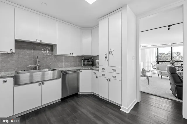 a kitchen with stainless steel appliances white cabinets and a stove