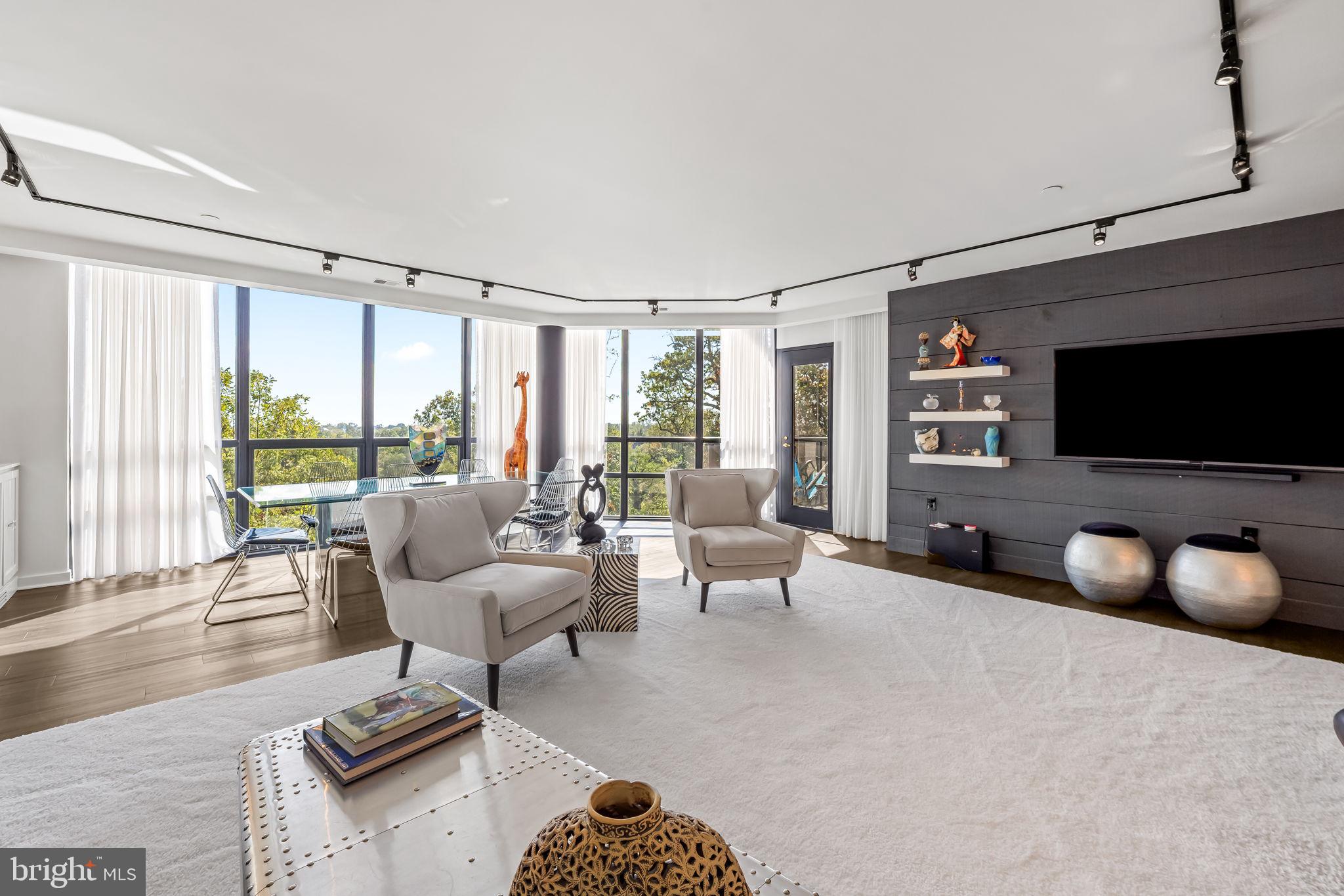 4001 Old Court Road, Unit 517 Baltimore, MD 21208 - Photo 21 of 38 a living room with furniture a flat screen tv and a large window