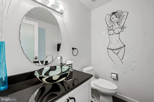 a bathroom with a toilet sink and mirror