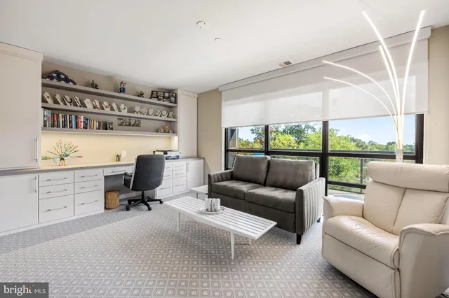 a view of a livingroom with workspace and a couch