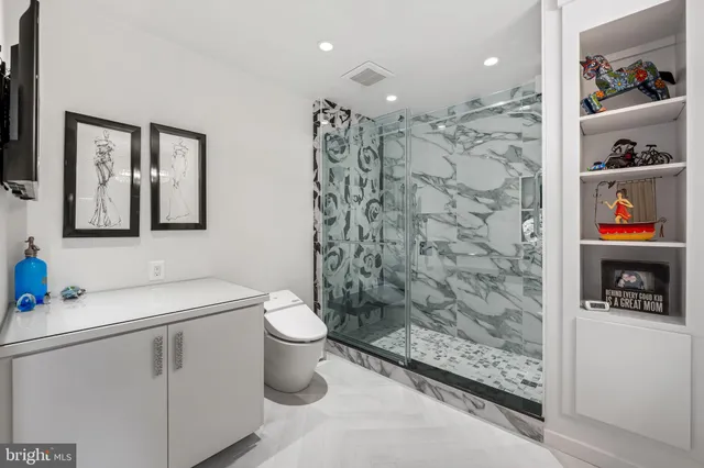 a bathroom with a sink toilet and shower