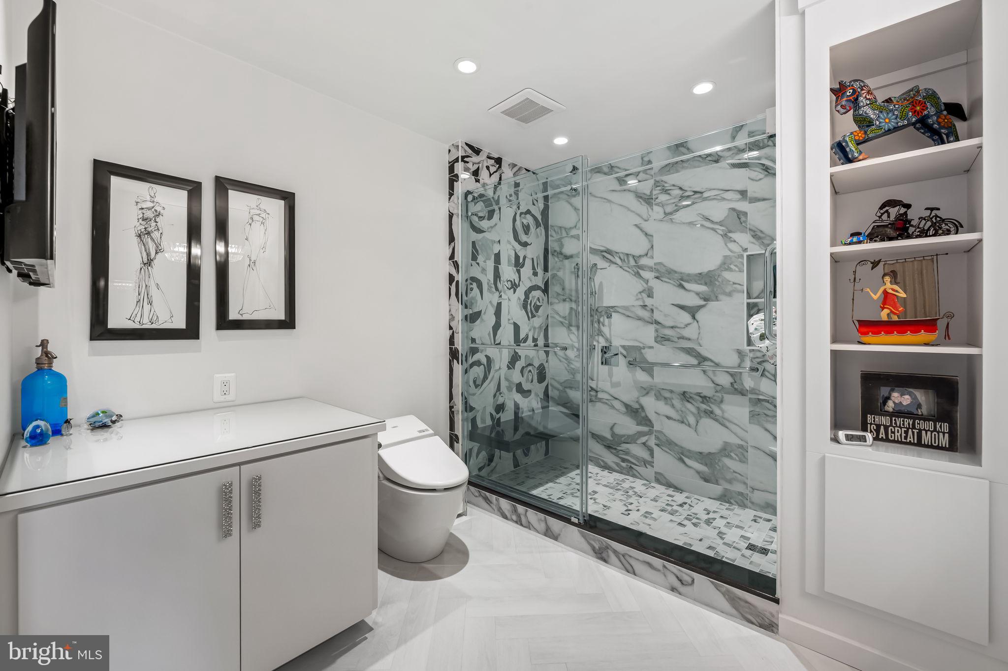 4001 Old Court Road, Unit 517 Baltimore, MD 21208 - Photo 29 of 38 a bathroom with a sink toilet and shower