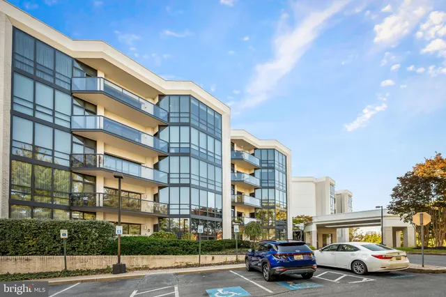 a front view of a residential apartment building with a yard