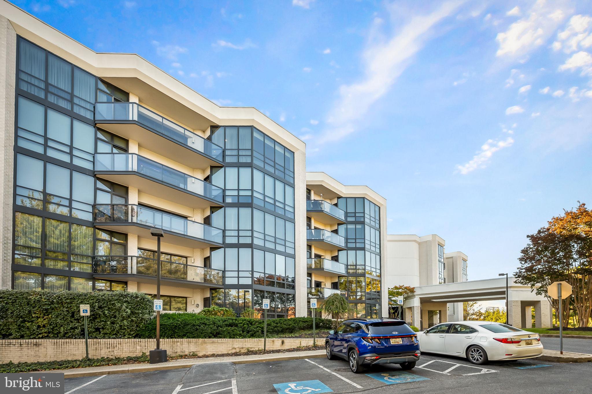4001 Old Court Road, Unit 517 Baltimore, MD 21208 - Photo 3 of 38 a front view of a residential apartment building with a yard