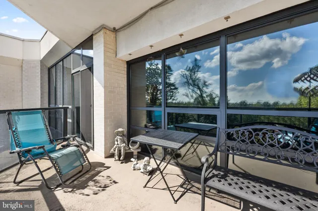 a view of a patio with table and chairs and potted plants