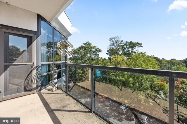 a view of balcony with wooden floor and fence