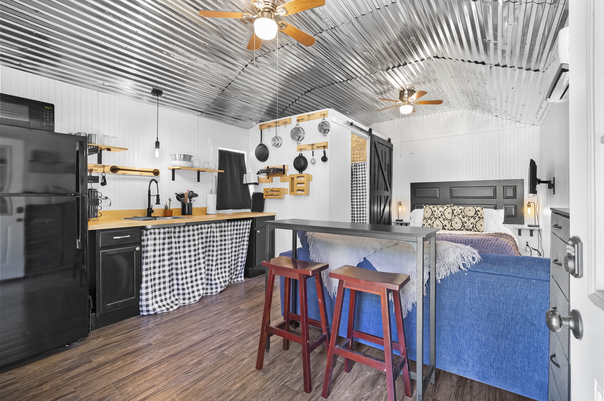 a kitchen with stainless steel appliances granite countertop a stove a sink a dining table and chairs