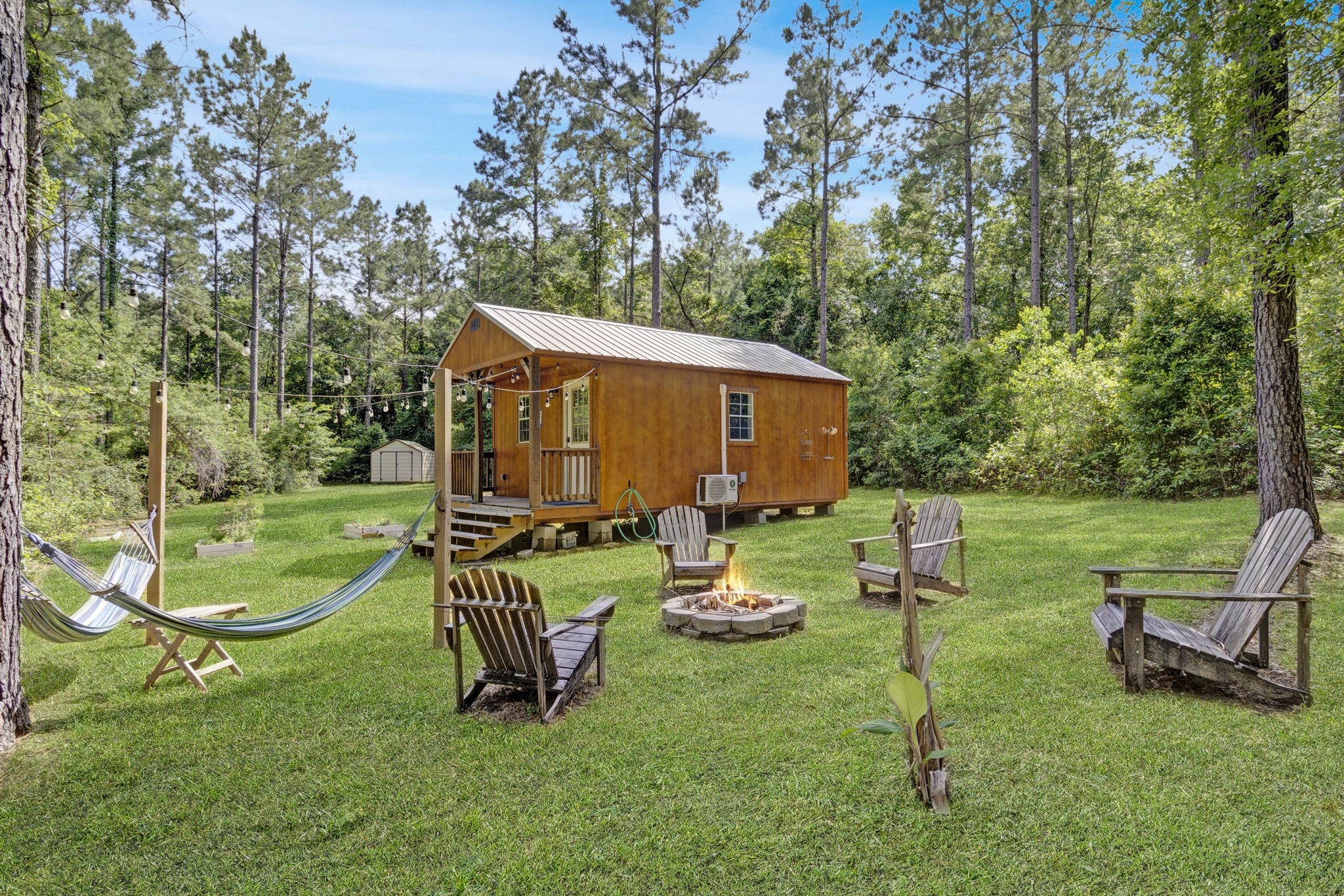 129 County Road 3160 Colmesneil, TX 75938 - Photo 6 of 40 Relax and unwind in the outdoor fire pit area, complete with seating and hammocks. Perfect for gathering under the stars.