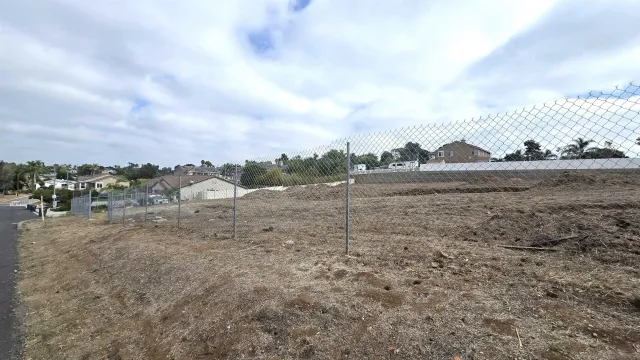 a view of an empty room with a window and a fireplace