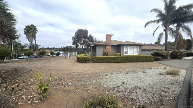 a view of a car park in front of a house