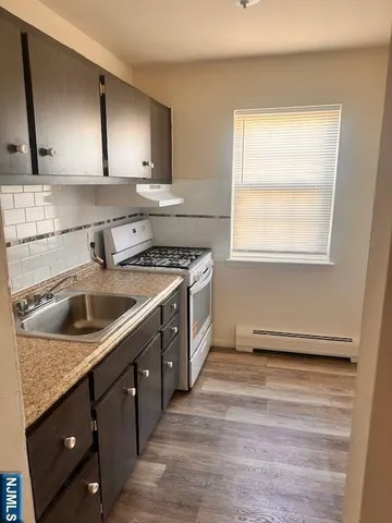 a kitchen that has a sink and a stove