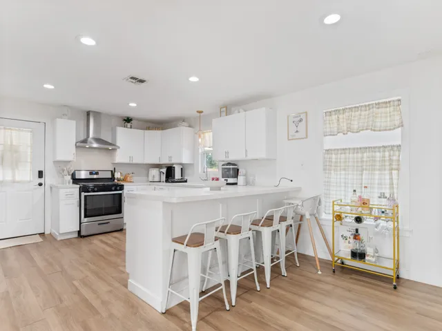 a kitchen with stainless steel appliances granite countertop a refrigerator and a stove top oven