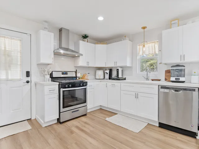 a white toilet sitting next to a bath tub and a shower