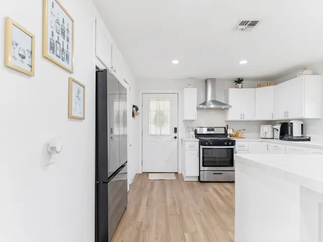 a spacious bedroom with a bed and a television