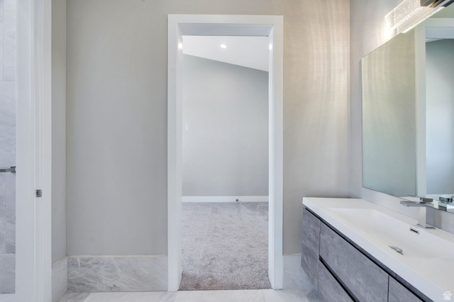 7045 South 300 East Midvale, UT 84047 - Photo 27 of 49 Bathroom vanity featuring an integrated sink, polished chrome faucet, and contemporary vanity lighting