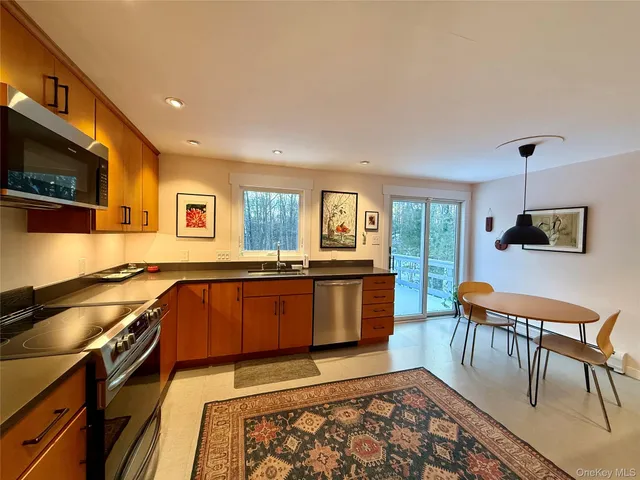 a kitchen with stainless steel appliances granite countertop a sink and cabinets