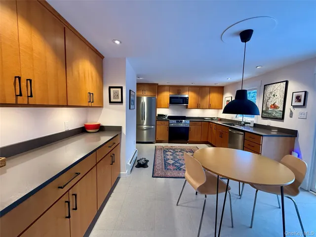 a kitchen with stainless steel appliances kitchen island granite countertop a sink and cabinets