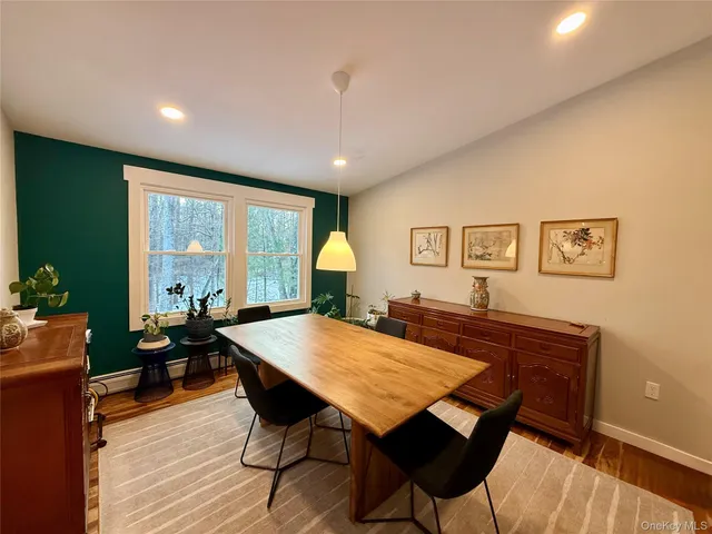 a view of a dining room with furniture window and wooden floor