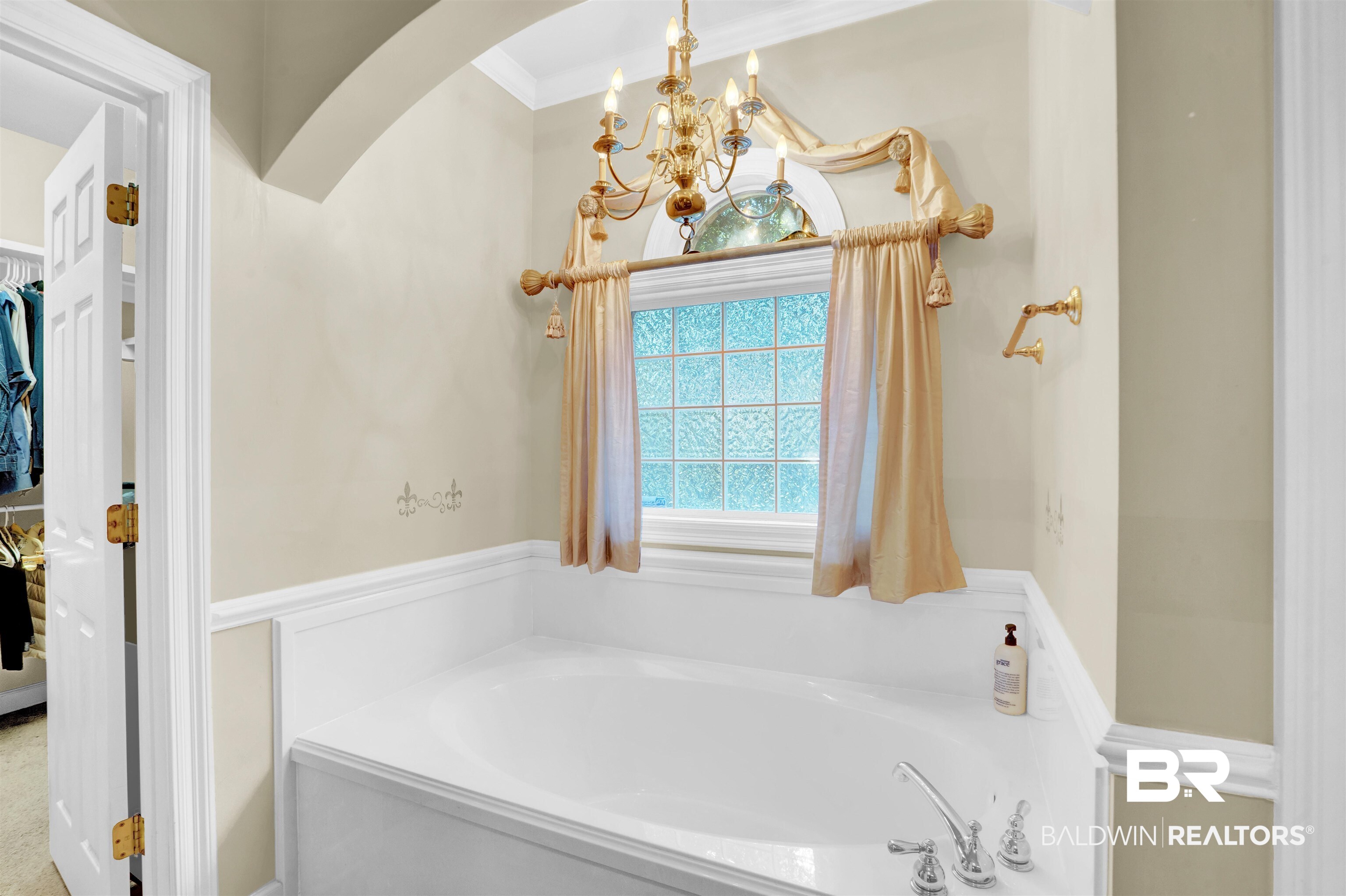 10951 Driver Court Fairhope, AL 36532 - Photo 28 of 46 Bathroom with ornamental molding, an inviting chandelier, and a bathing tub