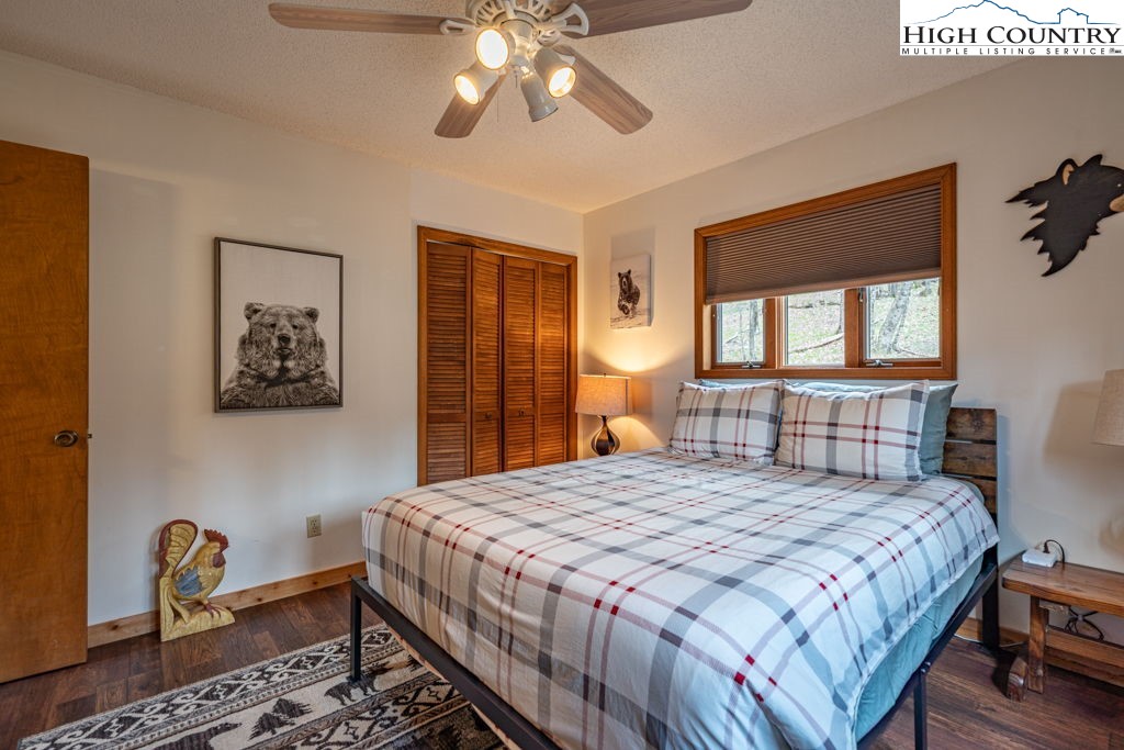 136 Tamarack Road Beech Mountain, NC 28604 - Photo 11 of 20 a bedroom with a bed and a chandelier