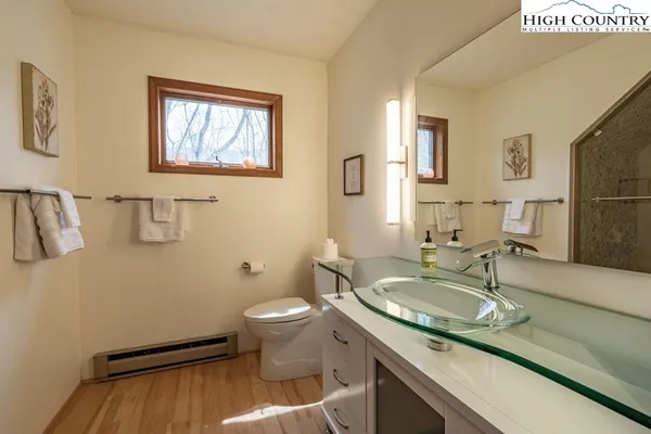 a bathroom with a sink toilet and mirror